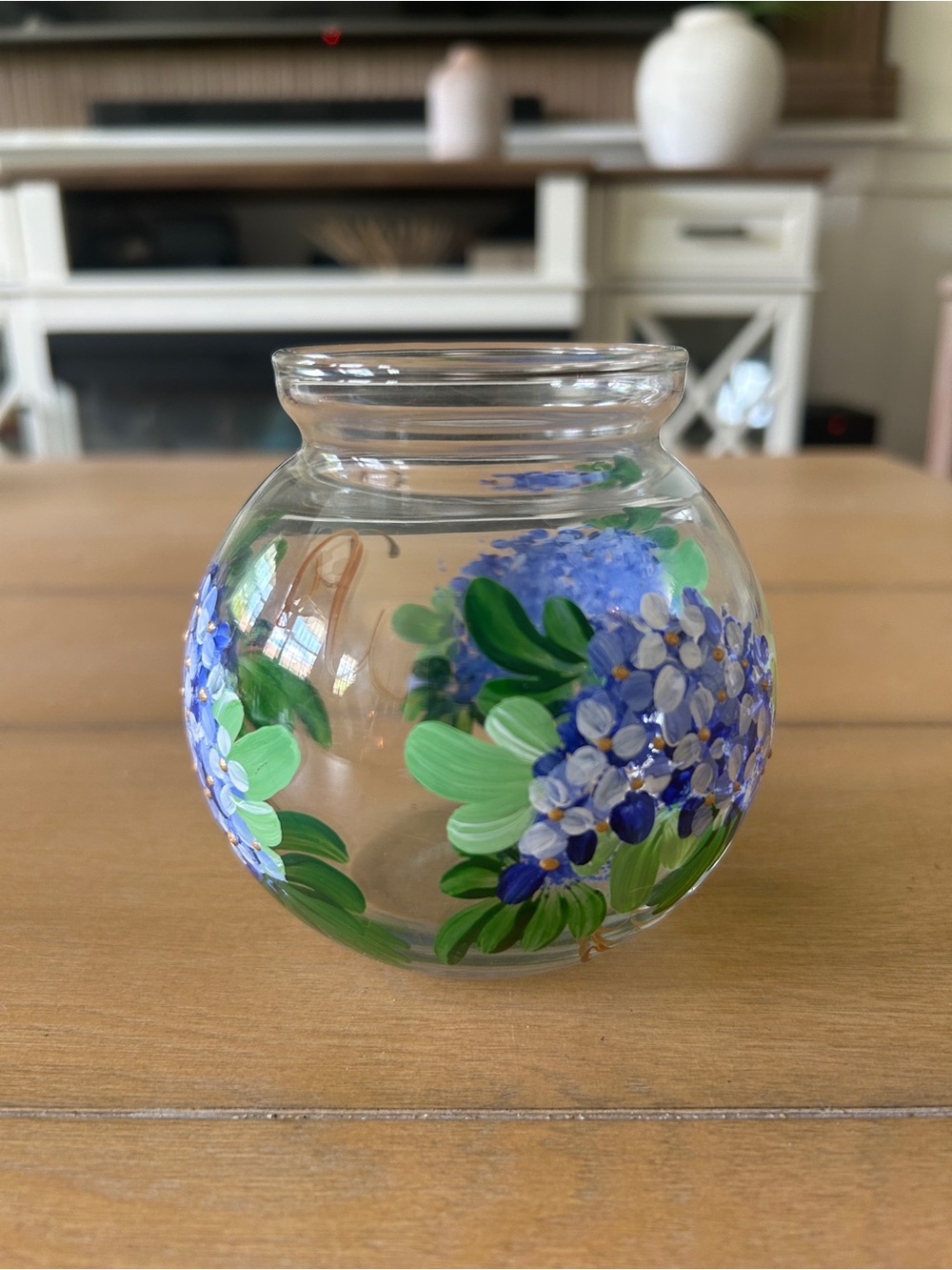 Small glass bud vase with blue purple flowers